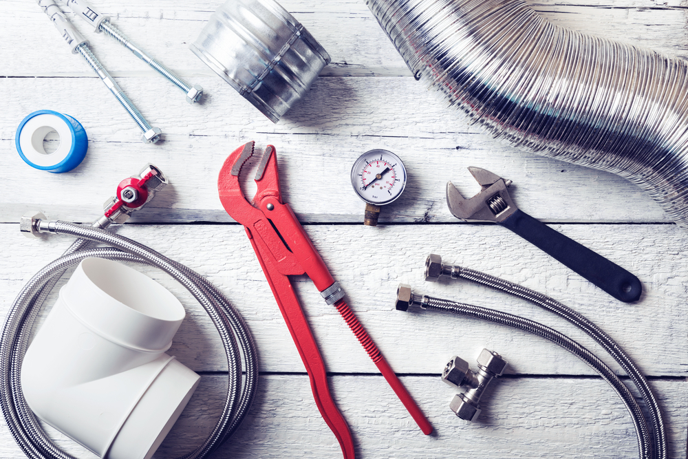Plumbing,tools,and,accessories,on,wooden,table.,top,view